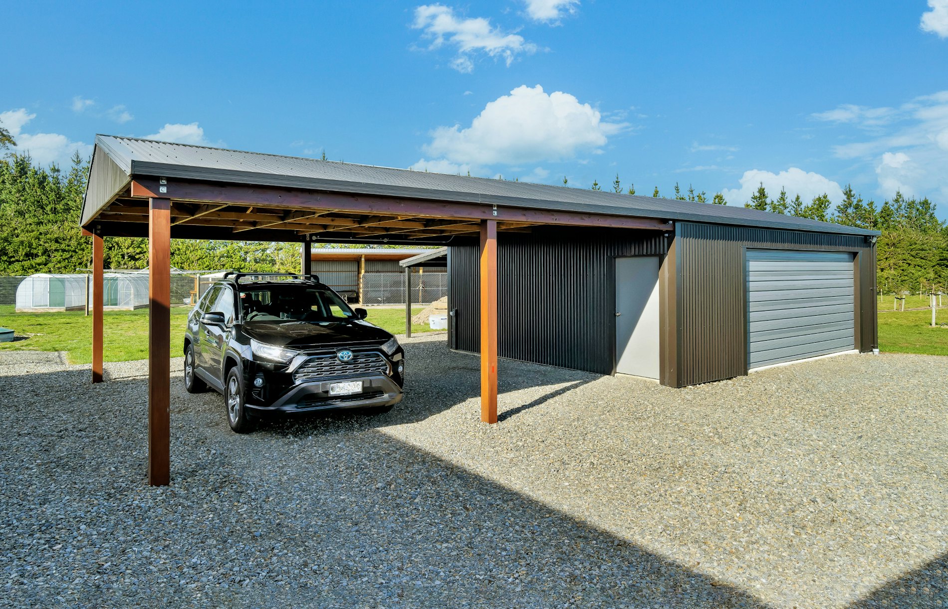 14.4m(l) x 6m(w) garage with dual carport, 2.4m stud, Superclad™ cladding in COLORSTEEL®  Ironsand.