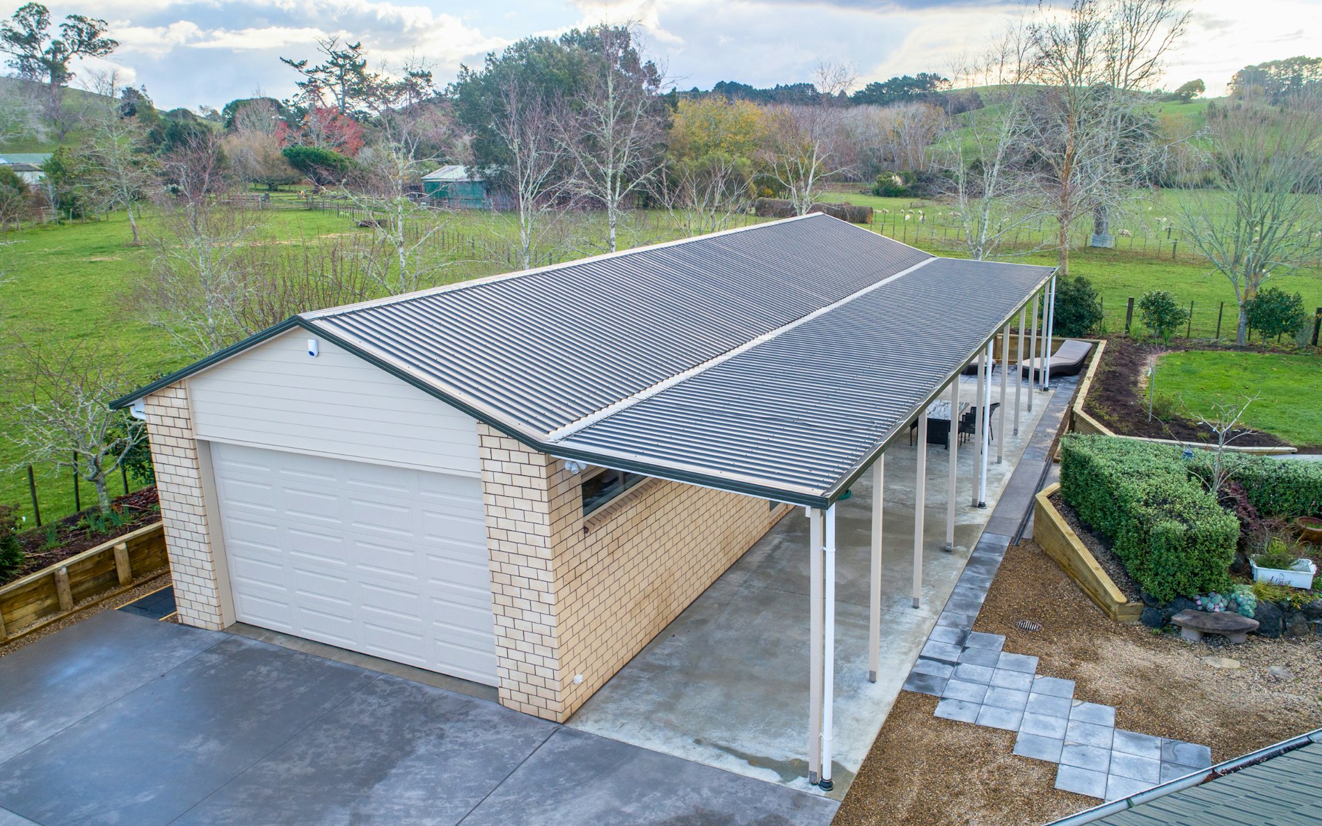  18m x 6m x 3m high. Cladding in brick with two separate vehicle entrances 1 x car & 1 x lawnmower plus a separate gym at the end