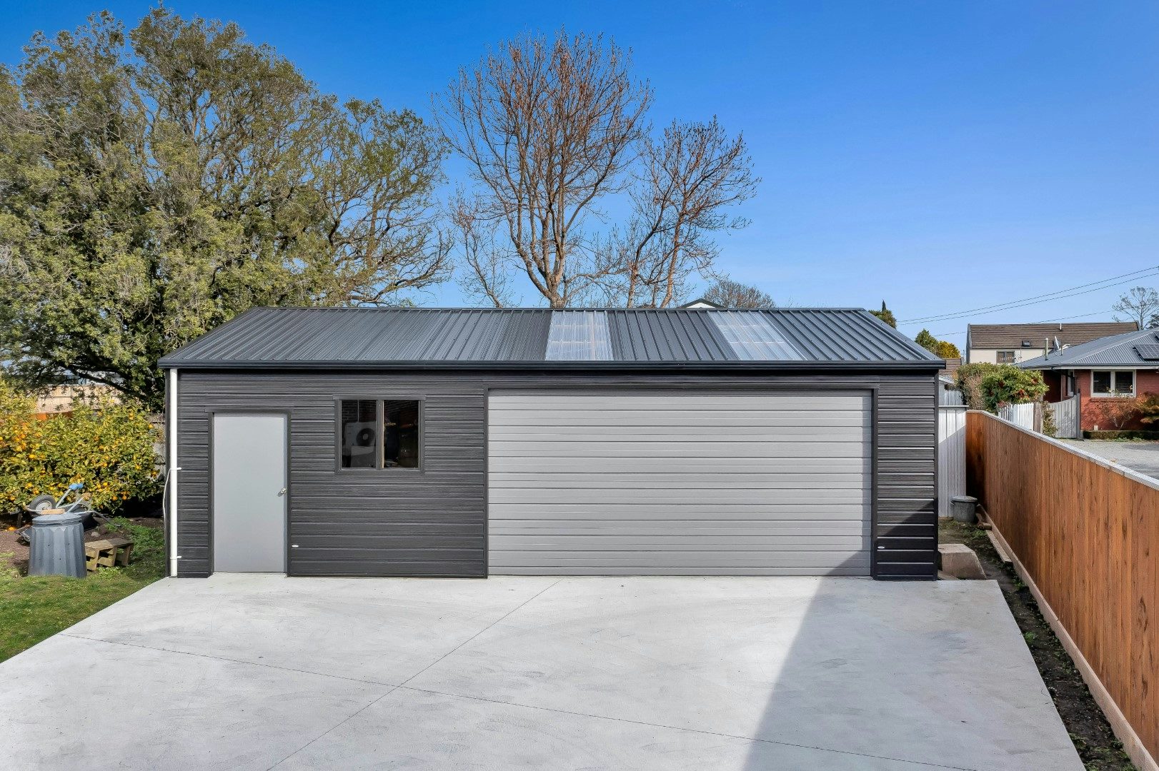 Chch - 9x6m Superclad, Roof Ebony, Walls Flaxpod, Door Sandstone