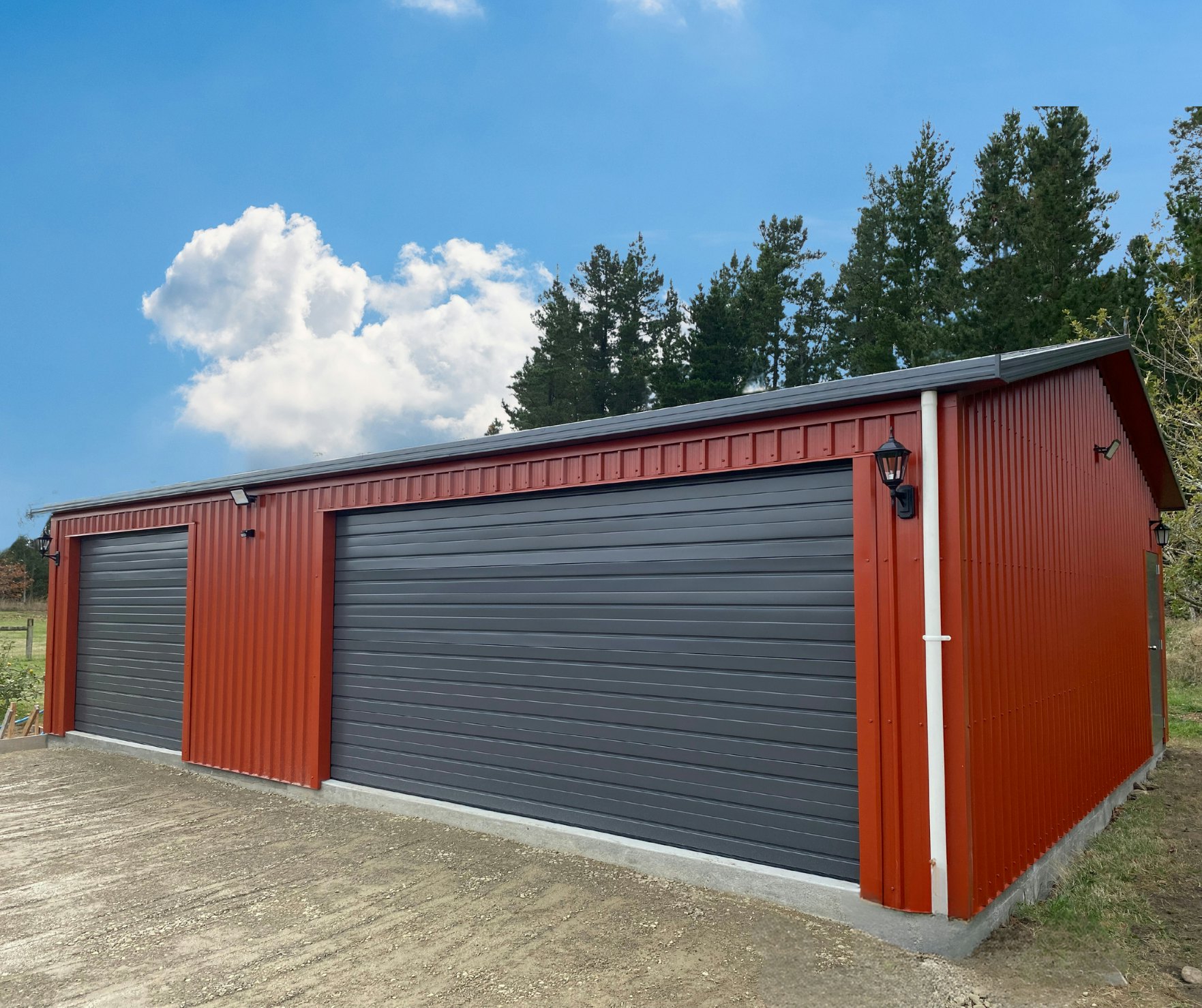10m x 7.2m large garage in Colorsteel Pioneer Red vertical cladding and Grey Friars roof and doors.