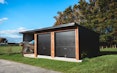 3 bay shed 2.8m wide bays x 6m depth two roller doors 6 rib Colorsteel cladding in Ebony and horizontal cedar