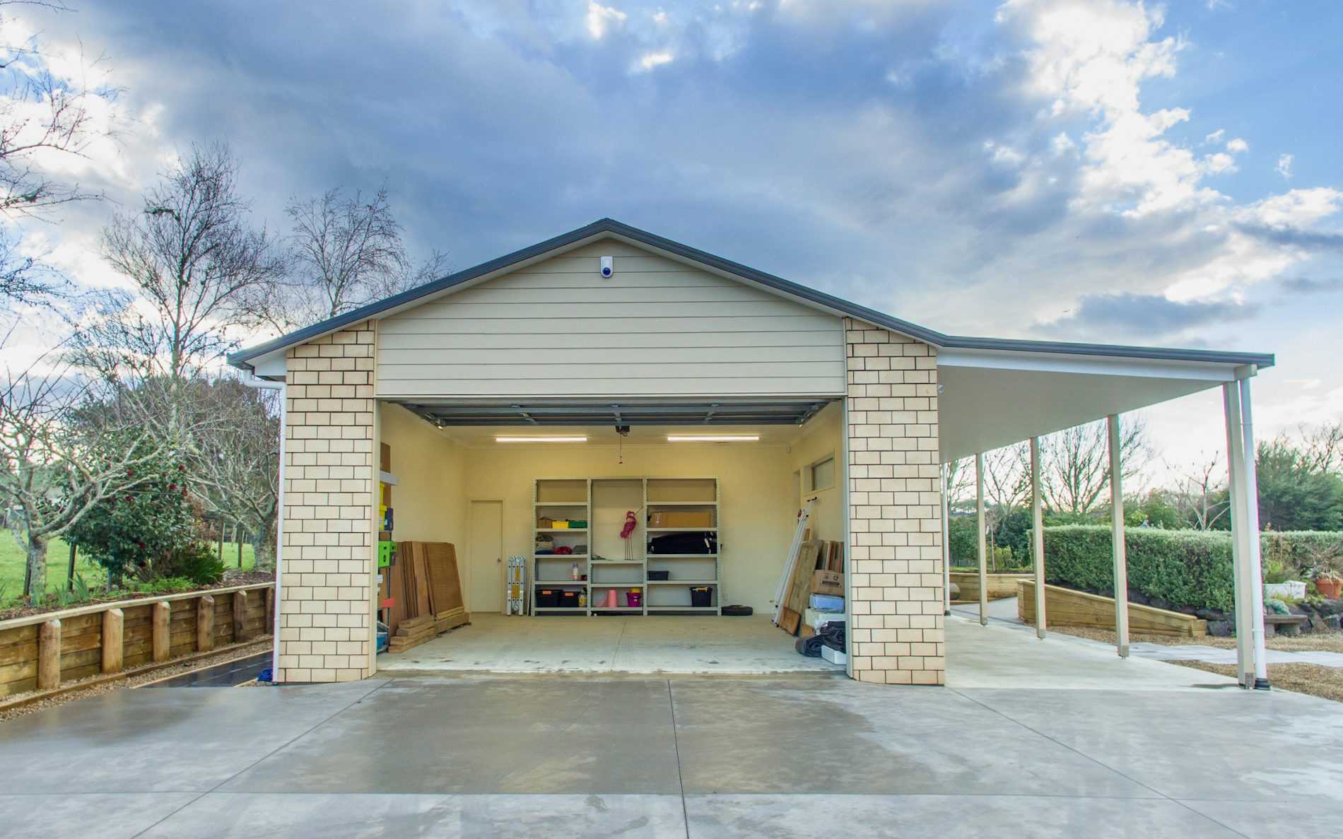  18m x 6m x 3m high. Cladding in brick with two separate vehicle entrances 1 x car & 1 x lawnmower plus a separate gym at the end