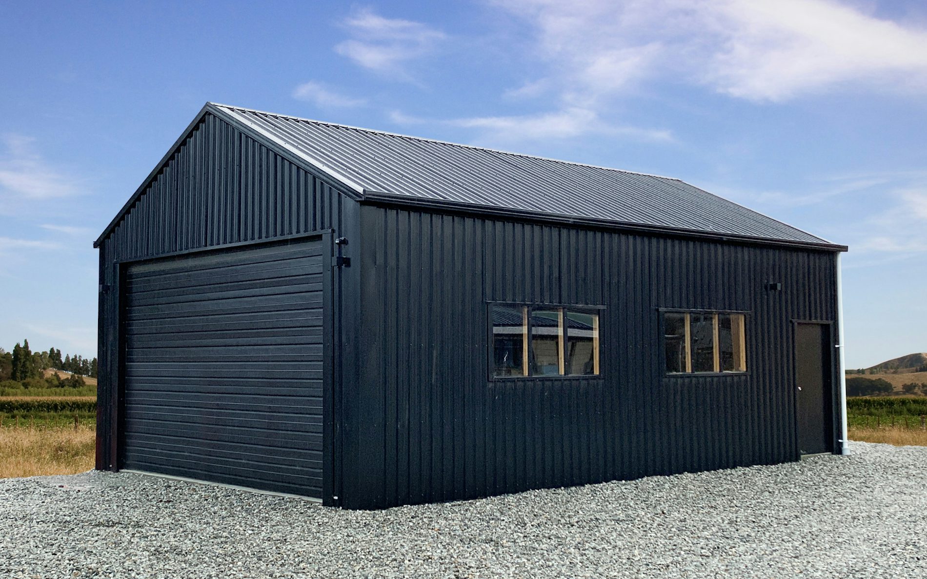 6m wide x 9m long x 3m stud garage, vertical 6 rib in Ebony with a Futura woodgrain sectional.
