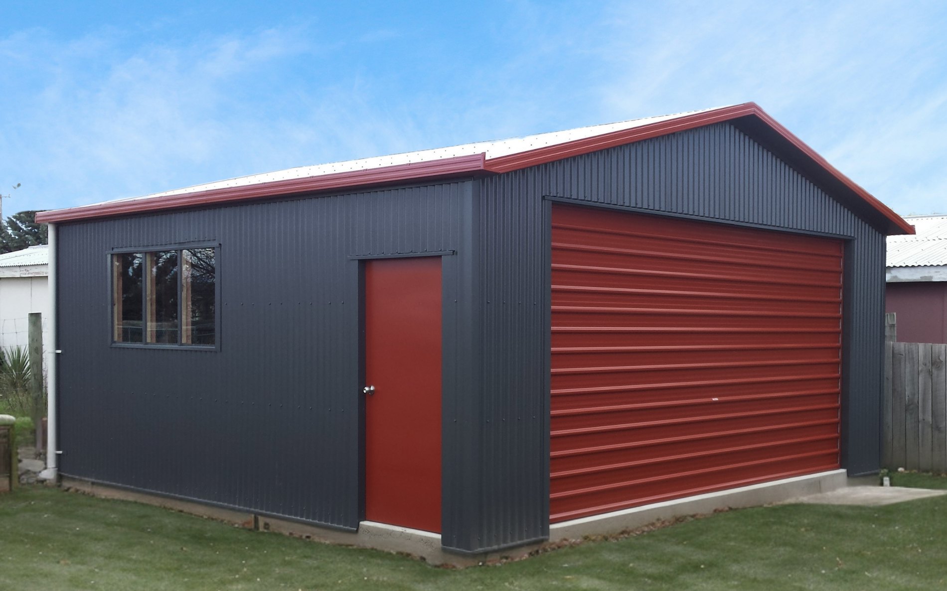 6m x 6m garage, Vertical Corrugate cladding  in COLORSTEEL® Grey Friars and Tilt door 4.5m wide Pioneer Red