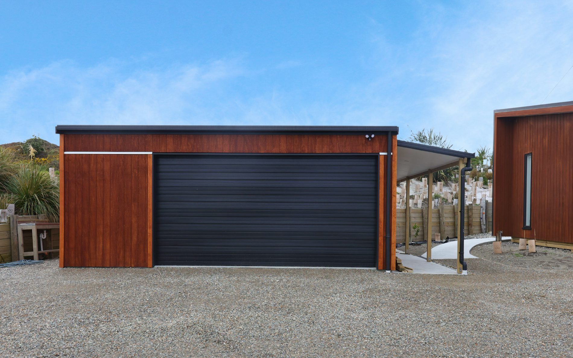 7m x 7.2m custom garage and storage, mono-pitch roof design in conjunction with stained shadowclad cladding