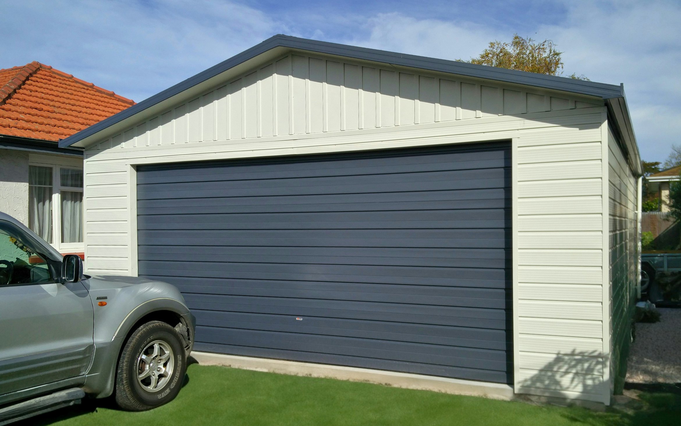 8m x 6m double garage, Superclad cladding  in COLORSTEEL® Titania and Sectional door 4.5m wide in New Denim Blue