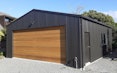 Custom double garage in vertical corrugate cedar main door aluminum windows