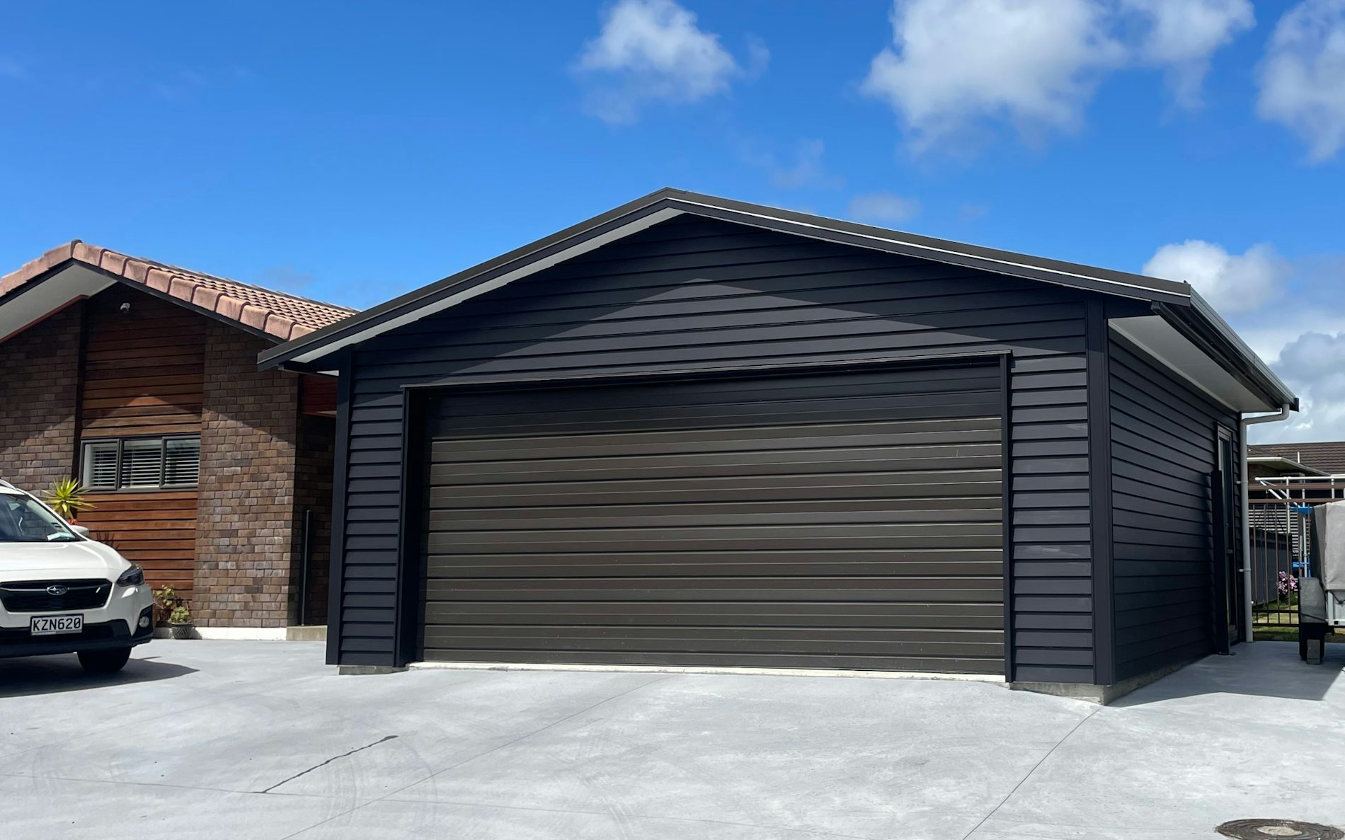 Custom double garage with timber weatherboard cladding 